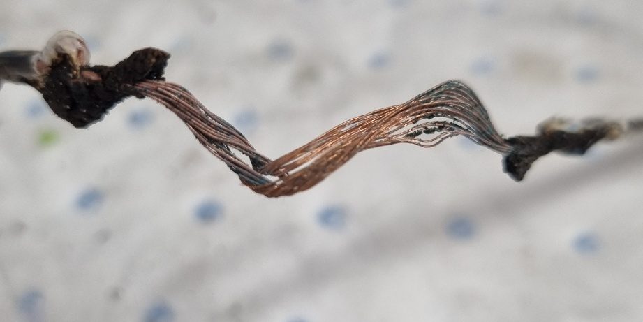 Conductor exposed after repeated cord flexing